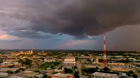 Panning landscape to see rainstorm rolling in to Dallas Skyline with rainbow. Video stock 164609265