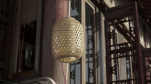 Panning: Lantern hanging against window in city on sunny day - Suzhou, China Stock Footage 149663893