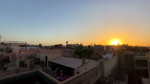 Panning left over rooftops and buildings in Marrakech at sunset Video stock 235794801
