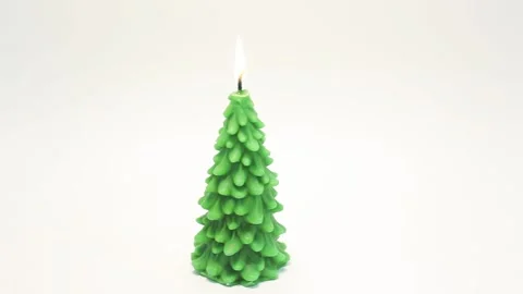 Panning from left to right of burning candle in shape of fir tree Stock Footage 143660127