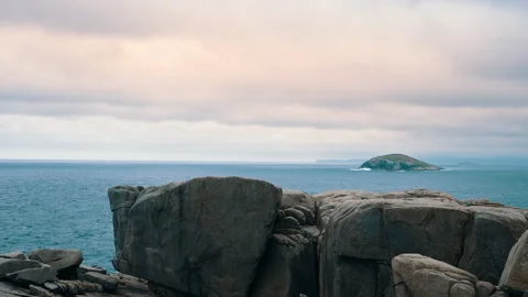 Panning from left to right at the gap, showing the rugged coastline and the stee Stock Footage 294616598
