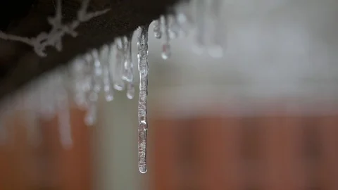 Panning left to right showing a closeup of an icicle hanging 스톡 동영상 102196903