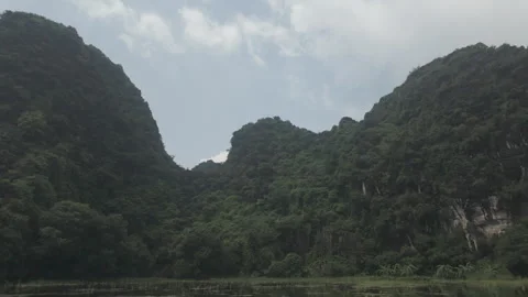 Panning left shot mountain to river shot in Tam Coc Stock Footage 291496526