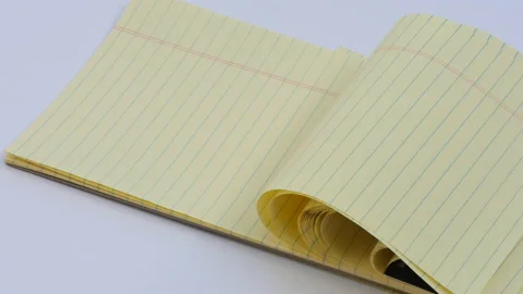 Panning Lined yellow note pad in wind Stock Footage 162641390