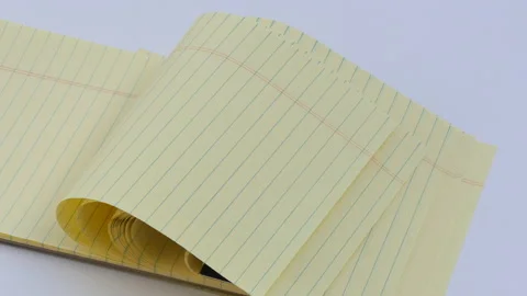 Panning Lined yellow note pad in wind Stock Footage 162641513