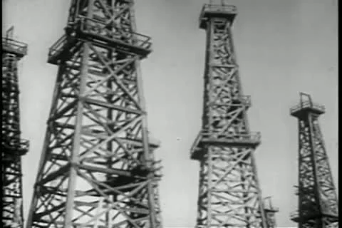 Panning low angle view distillation towers in oil field Video stock 11349411