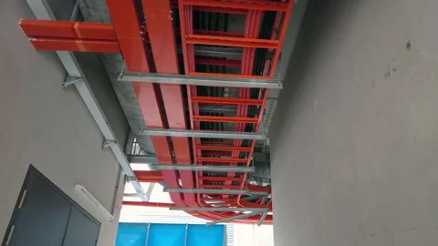 Panning low angle view of steel electrical cable trunking box hang on the cei Video stock 154837164