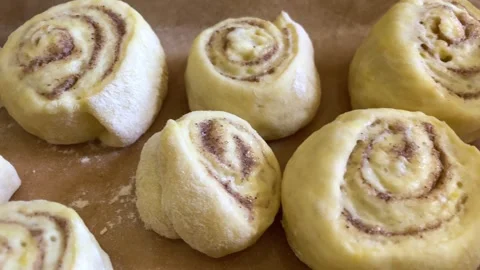 Panning macro closeup of small raw uncooked dough for cinnamon buns rolls swirl Stock Footage 246175299