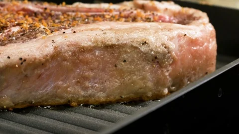 Panning macro shot of the steak being cooked on the stove 스톡 동영상 102611866