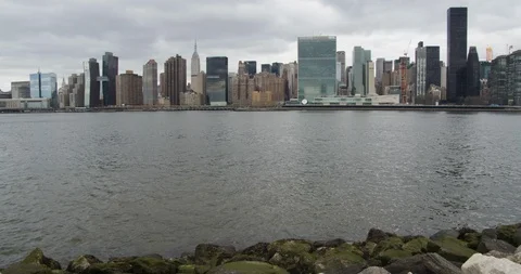 Panning up to Manhattan from Rocks Stock Footage 105293044