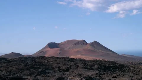 Panning medium shot of volcano crater, Lanzarote, Timanfaya. 4k Stock Footage 154553649