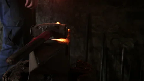 Panning motion of a hammer resting on a blacksmith's anvil Stock Footage 167860893