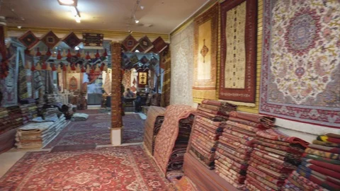 Panning motion inside carpet shop in the Grand Bazaar, Isfahan Stock Footage 100030048