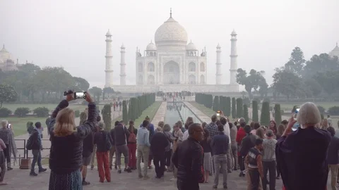 Panning motion of visitors taking pictures of the Taj Mahal Stock Footage 101291995