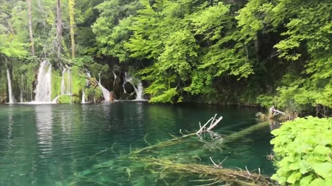 Panning movement shot of a small beautiful tranquil waterfall in the plitvice Stock Footage 131869296