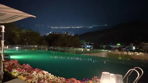 Panning Nighttime landscape from Dehradun featuring a luxury infinity pool, Stock Footage 336861842