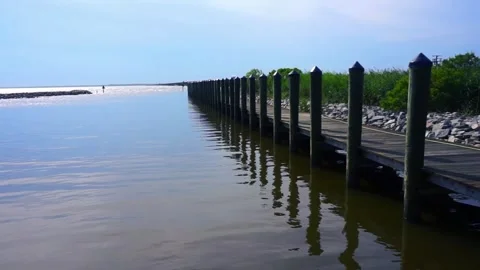 Panning Ocean Pier, Jetty ending up looking into sky Stock Footage 244800542