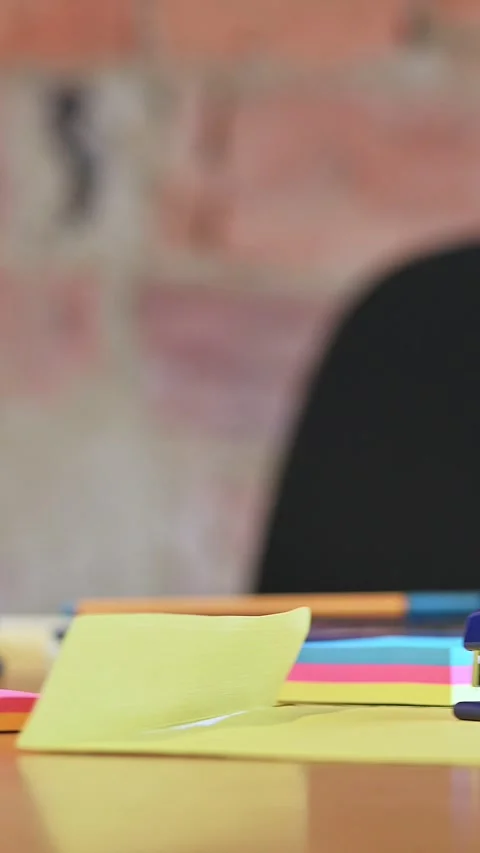 Panning at office work desk level with office stuff. 動画素材 336286837