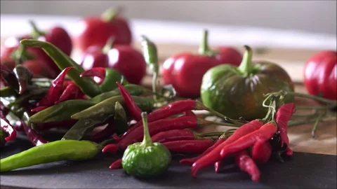 Panning on organic, fresh peppers on the table. Video stock 95078596