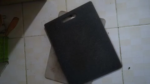 Panning Over Black Cutting Board On Kitchen Tiles Stock Footage 337661593