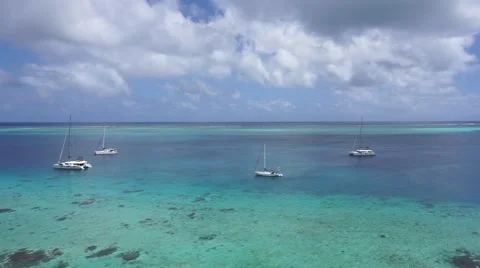 Panning over blue lagoon with few boats Stock Footage