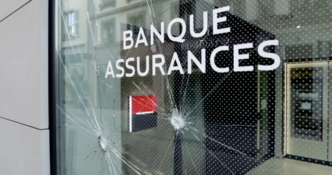 Panning over damaged Societe Generale bank branch window in central part of the Stock Footage 246089374