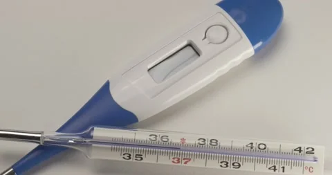 Panning over digital thermometer and glass mercury thermometer 4K Stock Footage 146582717