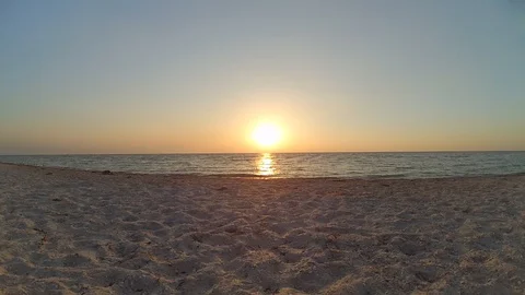 Panning over empty sandy beach and seashore during sunset or dawn. Stock Footage 87967014