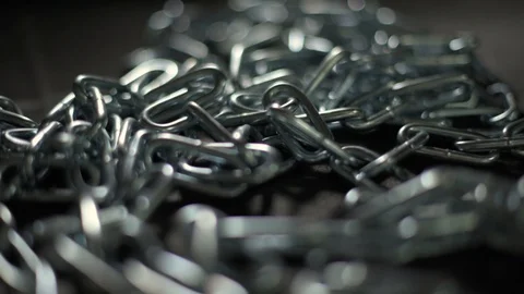 Panning over silver chain on black table 스톡 동영상 91599760