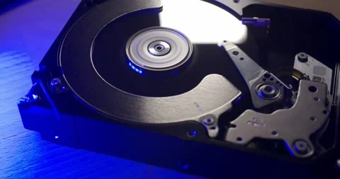 Panning over spinning and reading Hard Drive under blue and white light Stock Footage 132080596