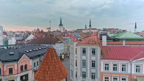 Panning over towers with small flag looking onto medieval Tallinn old town Stock Footage 88678381