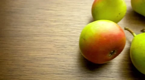 Panning overhead shot of fresh red and green pear fruits scattered on wooden  Stock Footage 62761007