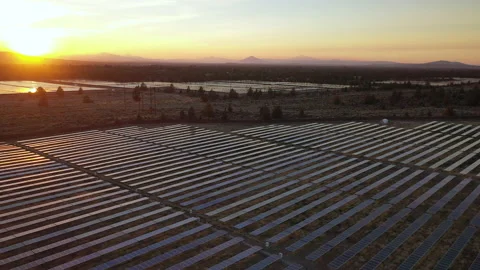 Panning overhead view of sunset with solar panels low in foreground Stock Footage