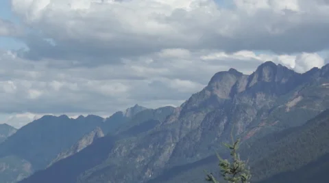 Panning past trees to show Mountain Range Stock Footage 44346269