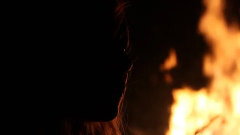 Panning up to person's face with flames near it Stock Footage 122801617
