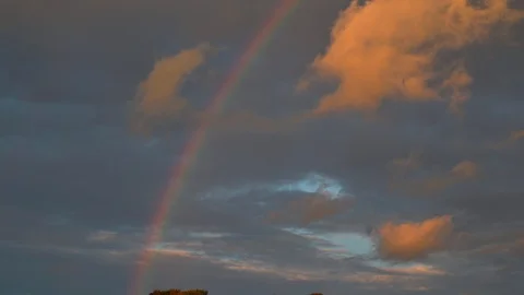 Panning of rainbow at sunset cloudy rainy day Stock Footage 106309120