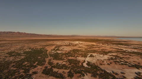 PANNING REVEAL OF DISTANT MOUNTAINS FROM DESERT IN CA AT SUNSET - 20 OF 30 Stock-Footage 331031482