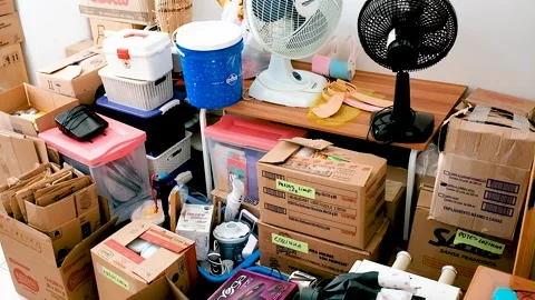 Panning reveal of various objects and boxes in living room 動画素材 152668300