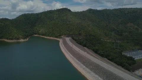 Panning right above dam under blue cloudy clear sky in Thailand with emerald lak Stock Footage 124010478