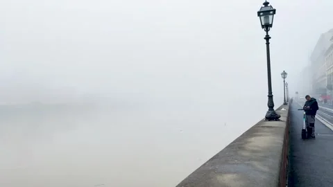 Panning to the right from a bridge by the lake on an extremely foggy day Stock Footage 264711734