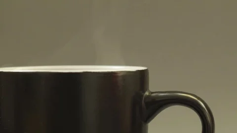 Panning to right close up of hot steaming cup of tea Stock Footage 80375298
