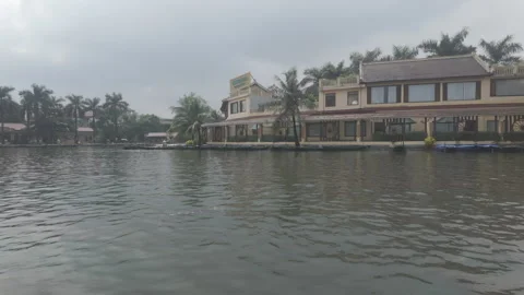 Panning right on cloudy day showing buildings beside river Stock Footage 290076922