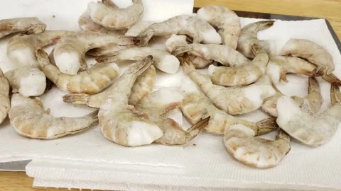 Panning right to left of frozen headless and with shell shrimps Stock Footage 166906464