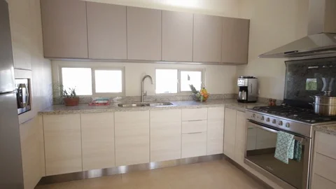 Panning from right to left of modern kitchen 스톡 동영상 115210455