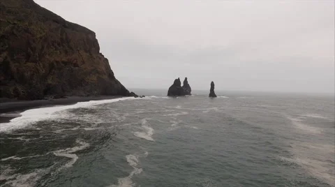 Panning Right Over The Sea Viewing 4 Protruding Rocks At Vík Iceland Vídeos de archivo 64073128