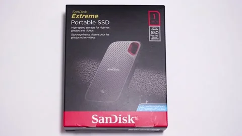Panning right on a SanDisk SSD Drive box on a white background.store. Stock Footage 157503928