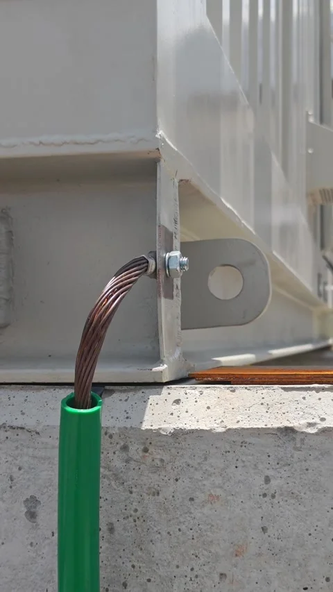 Panning right video of a bare copper grounding wire connected to a metal. Stock Footage 339022260