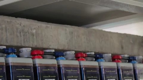 Panning right video of red and blue industrial backup battery bank terminals. Stock Footage 339022292
