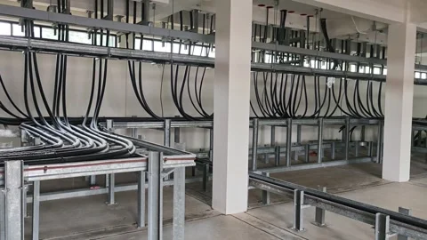 Panning right view of industrial electrical cable room showing black power. Stock Footage 340080086