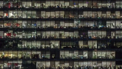 Panning to right view of office windows with working people Stock Footage 123007930
